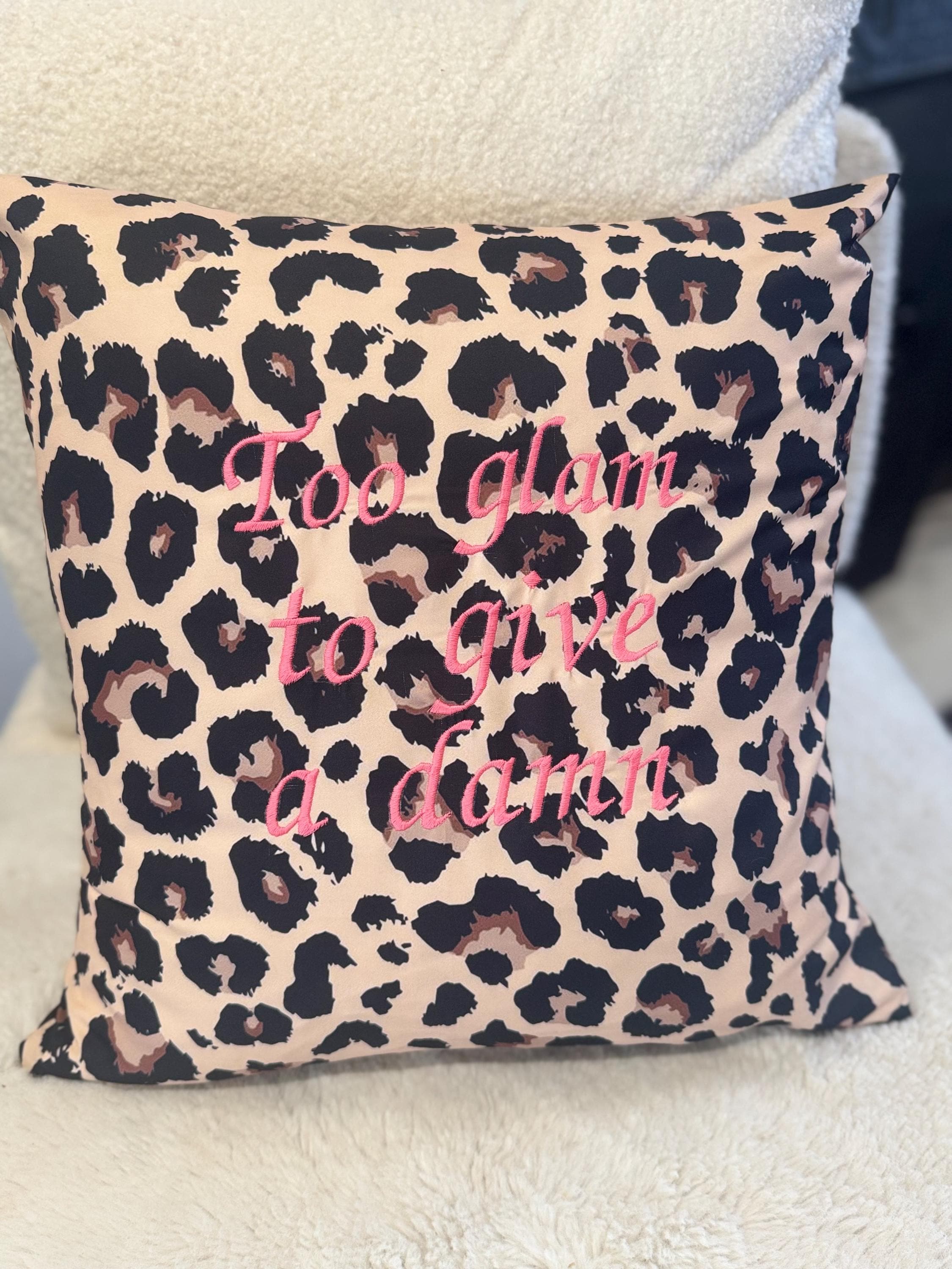 Leopard print cushion cover with’Too glam to give a damn’  embroidered in pink.