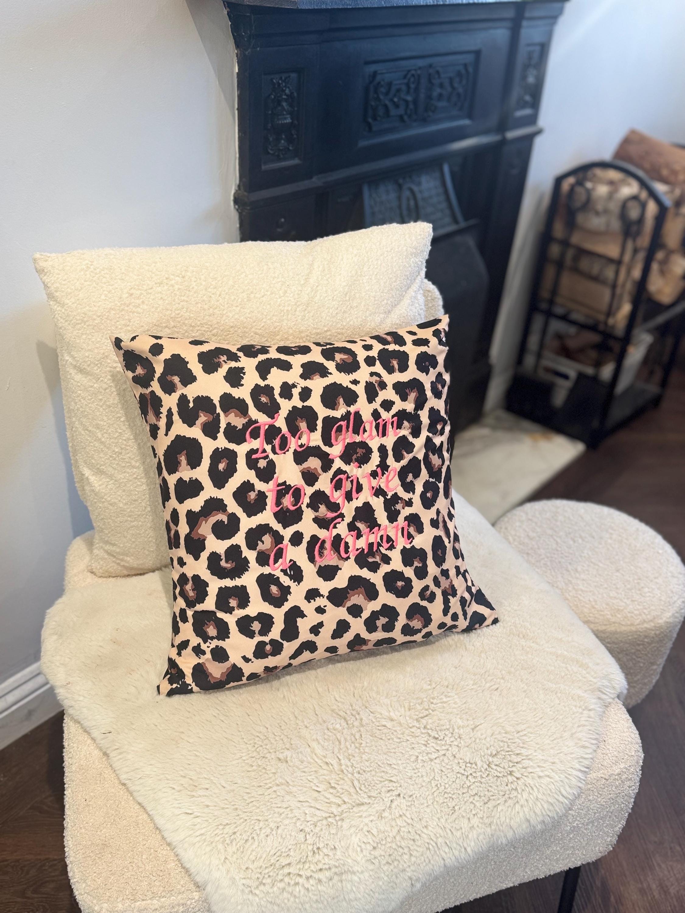 Leopard print cushion cover with’Too glam to give a damn’  embroidered in pink.
